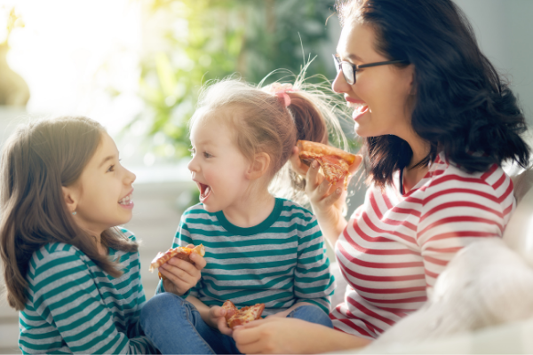 Thrive by Spectrum Pediatrics image for Parents Magazine article how junk food could help your picky eater by Virginia Sole Smith is a mother with her two children during mealtime