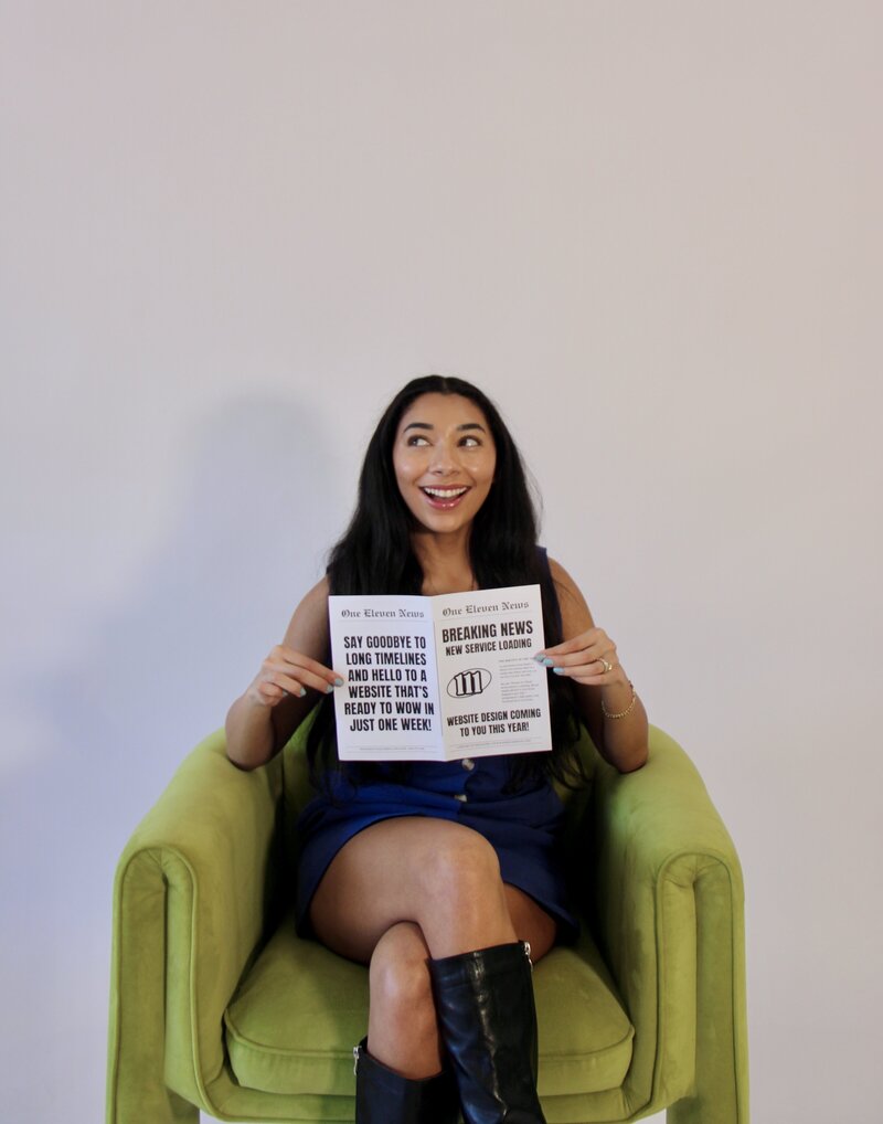 Bri holding a newspaper announcing 'Website in a Week'—a done-for-you web design experience.