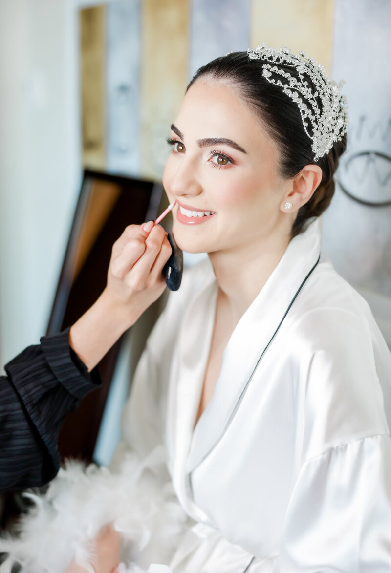The bride getting her makeup done at a wedding at the Four Seasons Orlando by Florida Wedding photographer. 