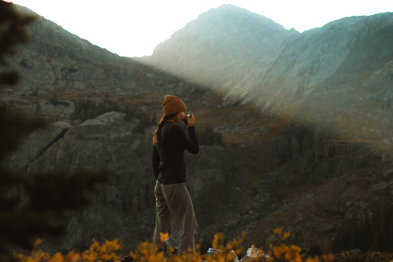 Ashley Rae photographing enjoying a scenic view in the Black Hills, highlighting her passion for outdoor photography