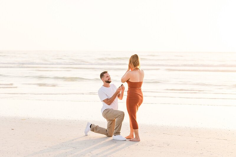 man proposing to a woman on the beach