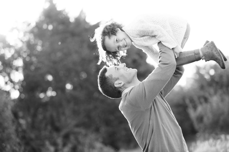 Dad holding little girl over his head in Orlando Family Photo