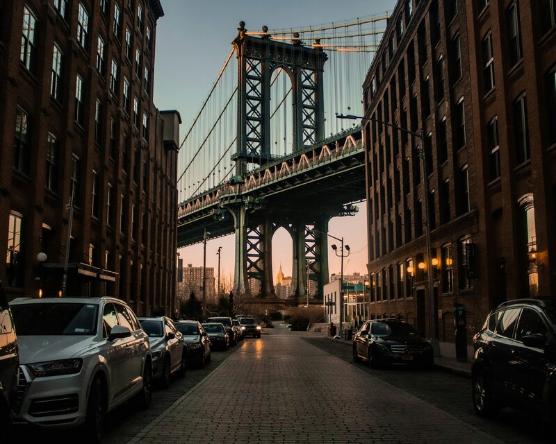 View of the Manhattan Bridge and NYC skyline from a street in Brooklyn.