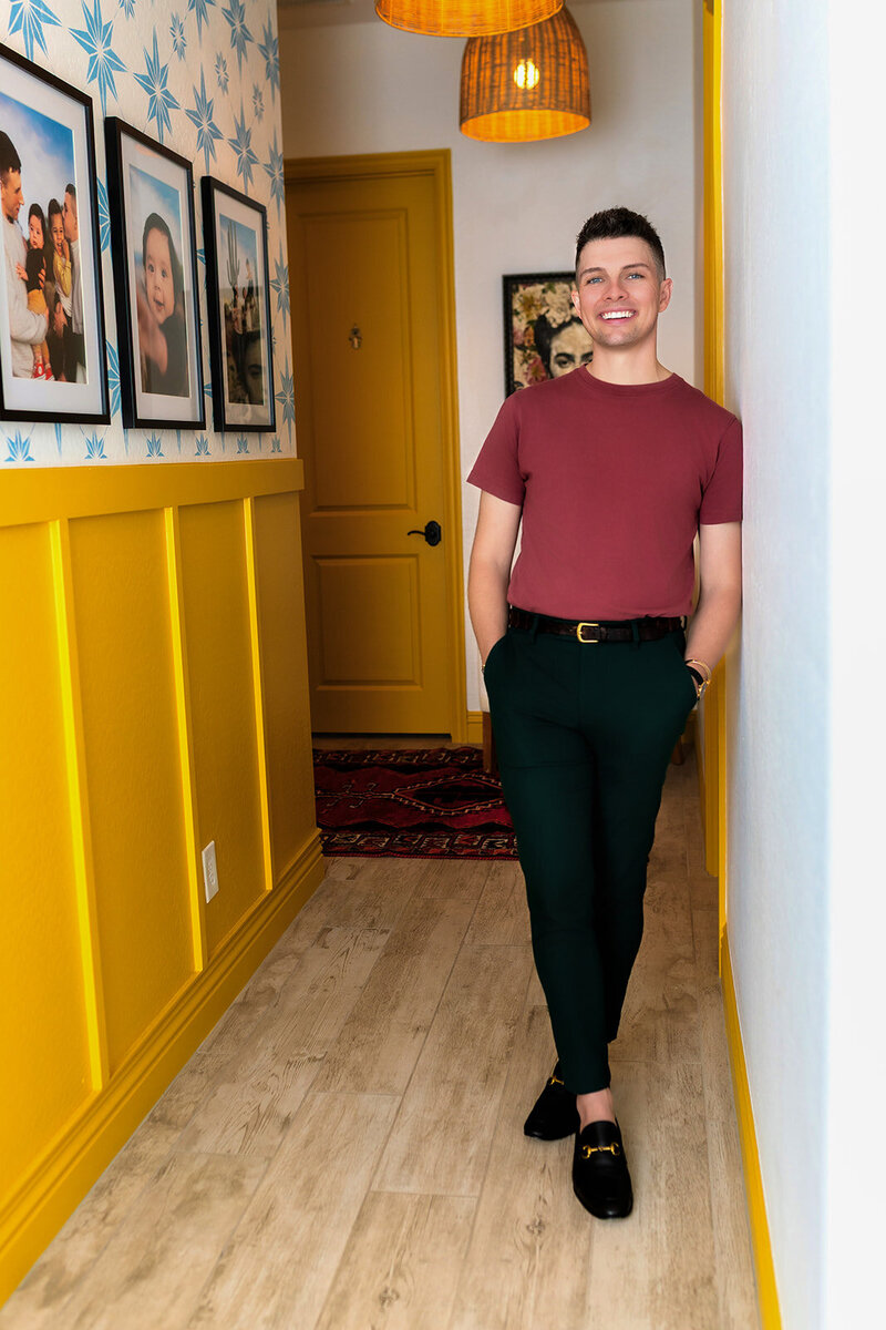 Madison Wetter, a Cave Creek resident and real estate agent. Sitting in a chair wearing a colorful blue oversized t-shirt.
