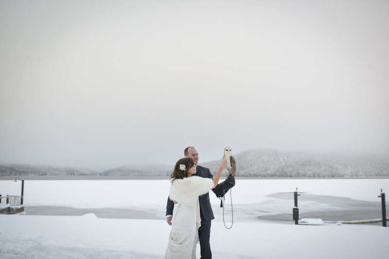 Lake placid wedding couple posing with owl for wedding videography