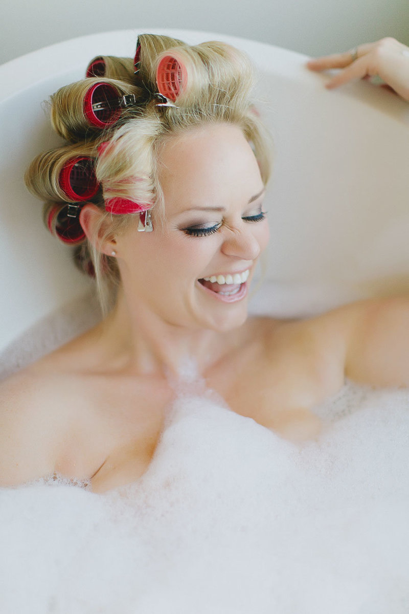 Blonde women with curlers in hair in bath