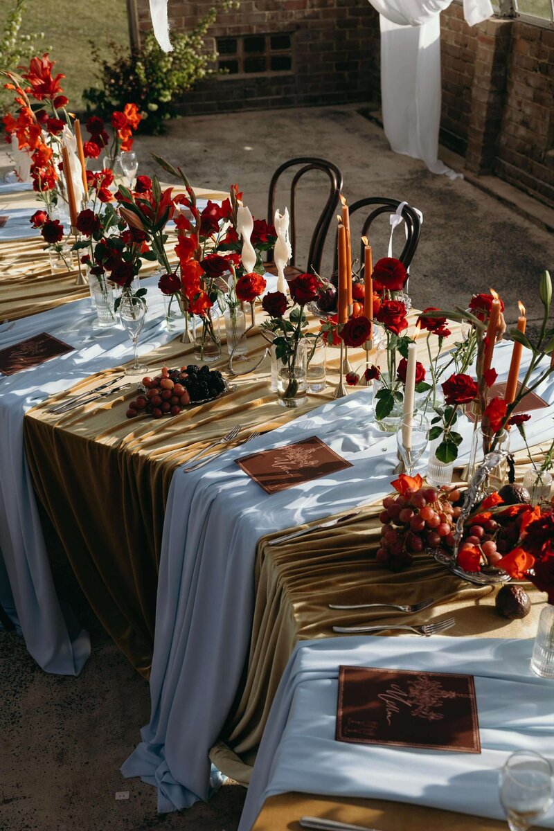 curved-table-red-flowers-gold-velvet