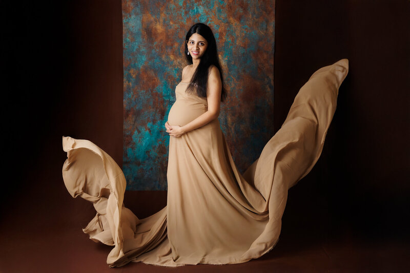 luxury maternity photos with tan flowing fabric