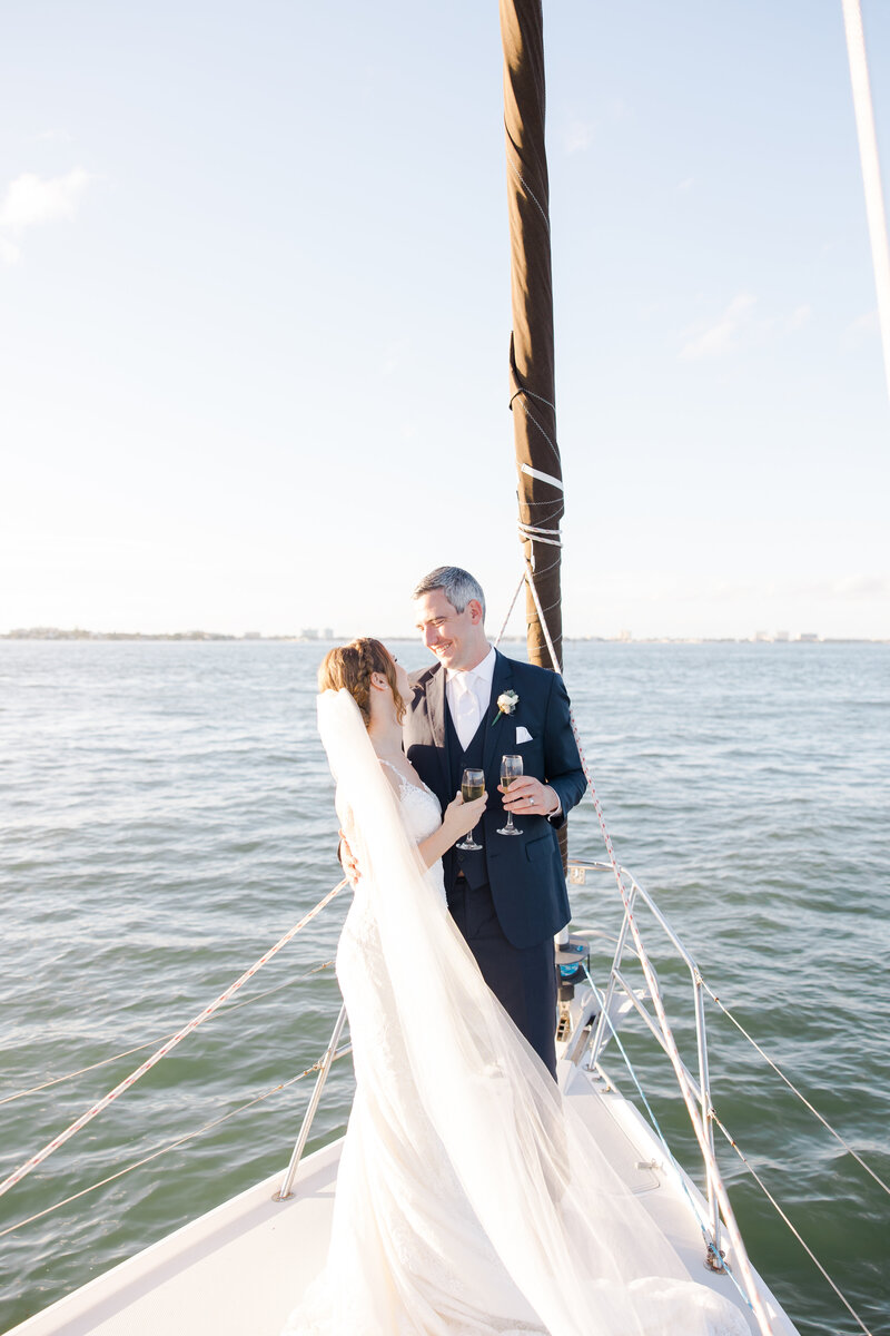 bride and groom drinking on a boat