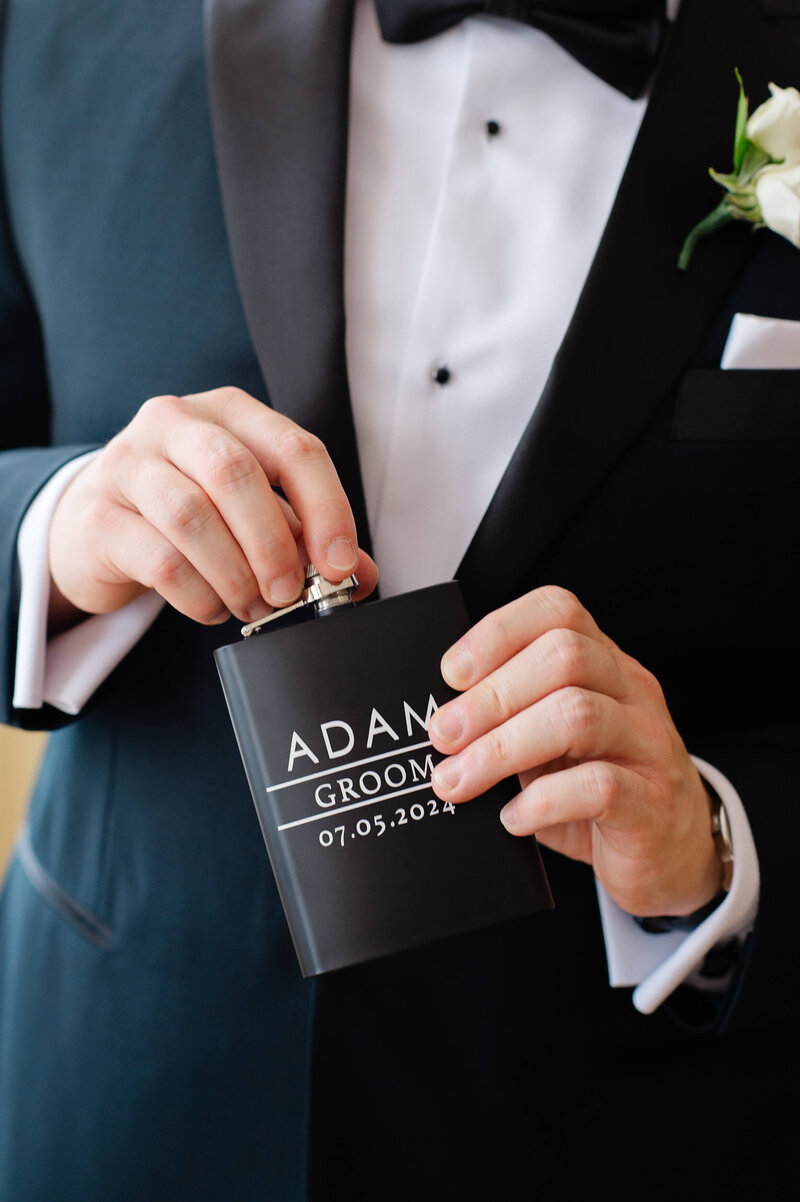 Ottawa wedding photography showing a closeup photo of an engraved groom's flask showing the wedding date