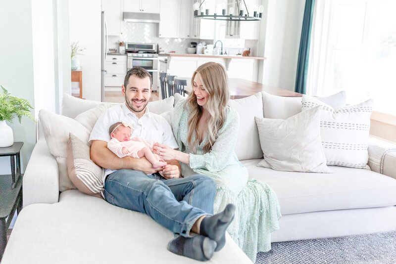 Lifestyle Newborn Session taken by Ann Arbor Maternity Photographer, Mom and Dad with newborn in their home
