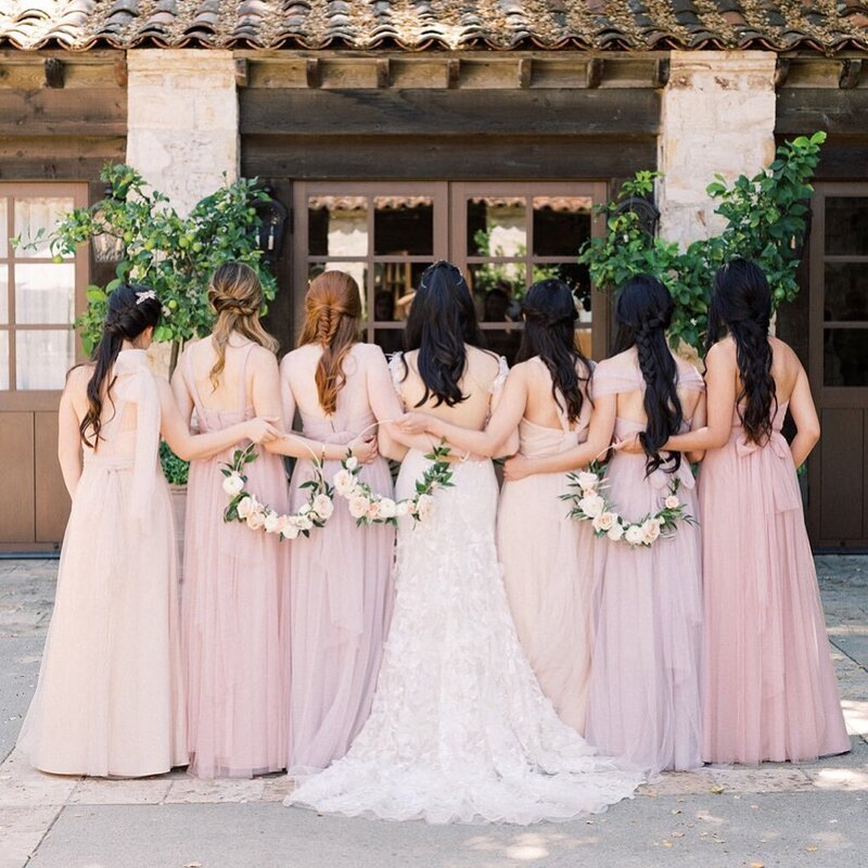bridal party holding each other