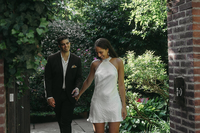 couple walking in NYC engagement photos, captured by Elsie Goodman, an NYC engagement and couples photographer
