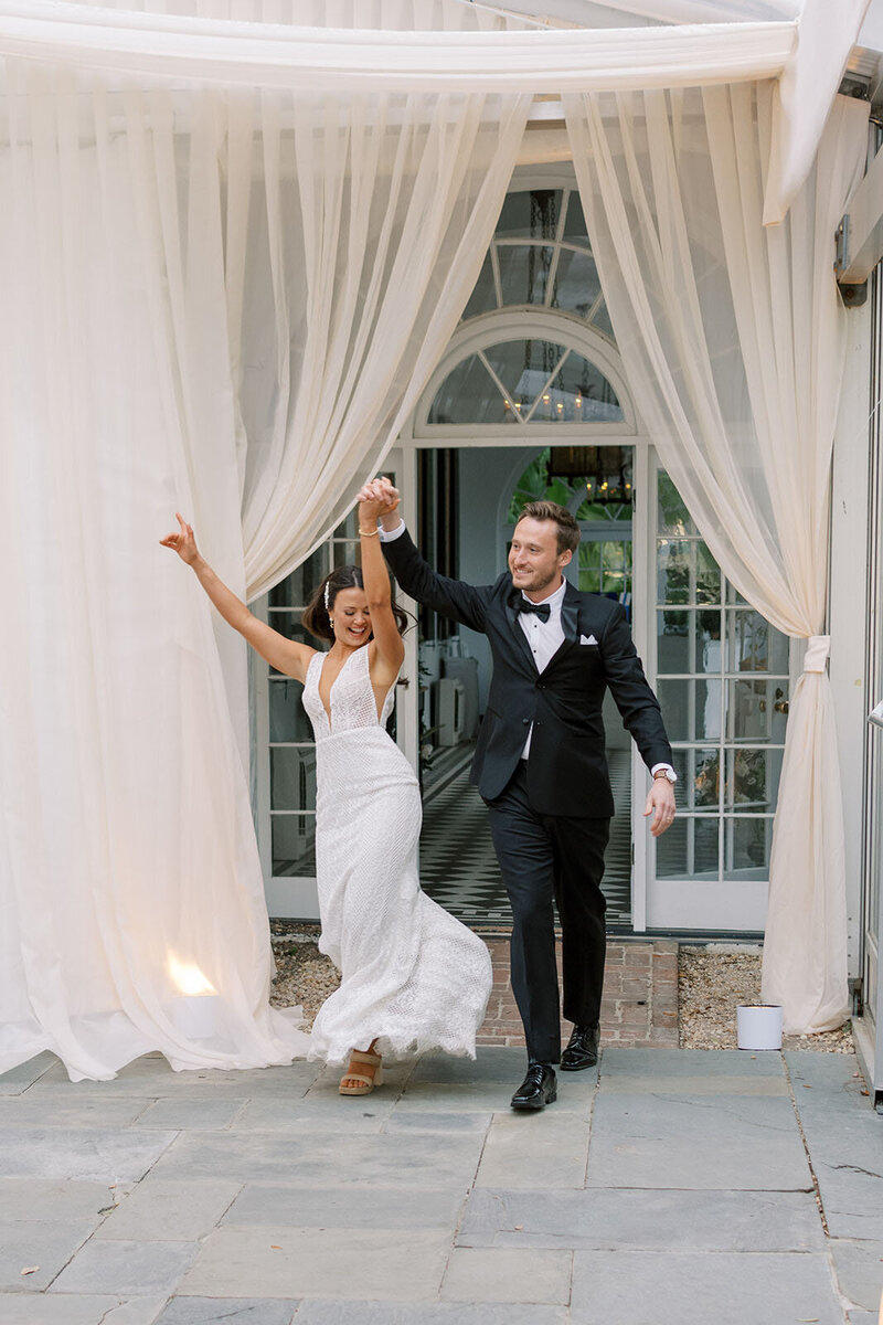 bride and groom entrance into tented reception