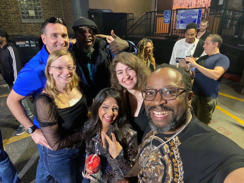 Group selfie with DJ and friends at night event