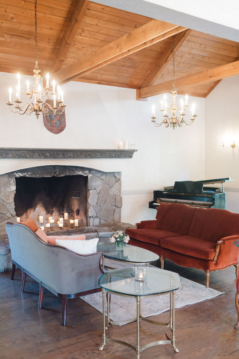 Cozy lounge area with vintage furniture and candlelit fireplace