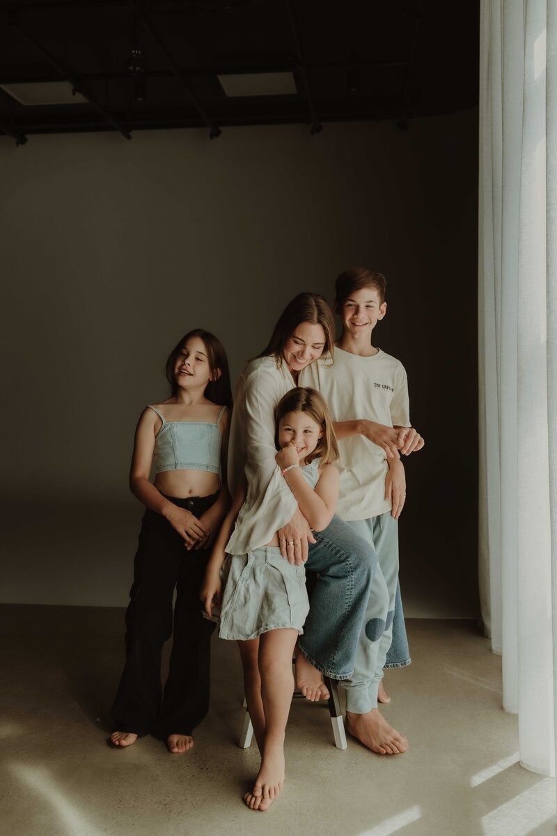 Family portrait with mother and three children, taken by Sydney family photographer.