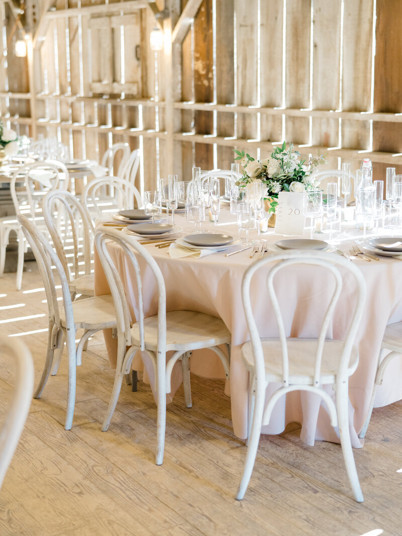 wedding reception tables in a white barn