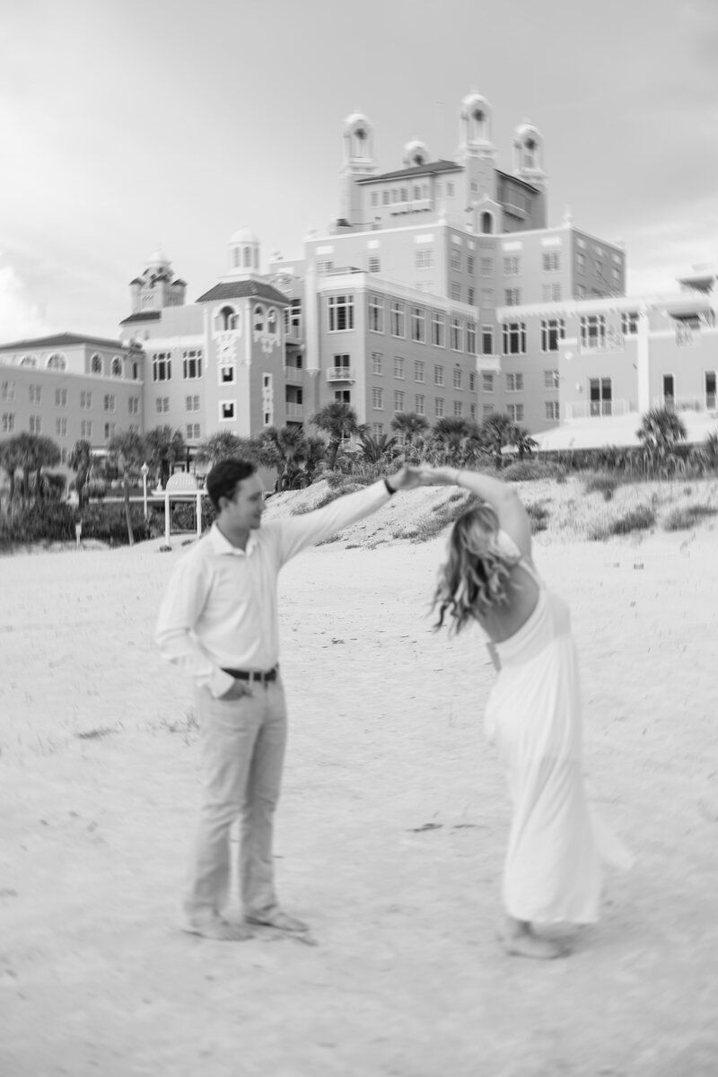 engaged couple walking while holding hands