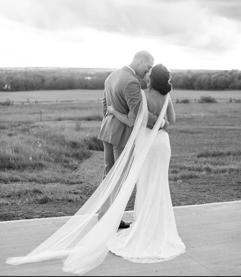 A bride and groom kissing.