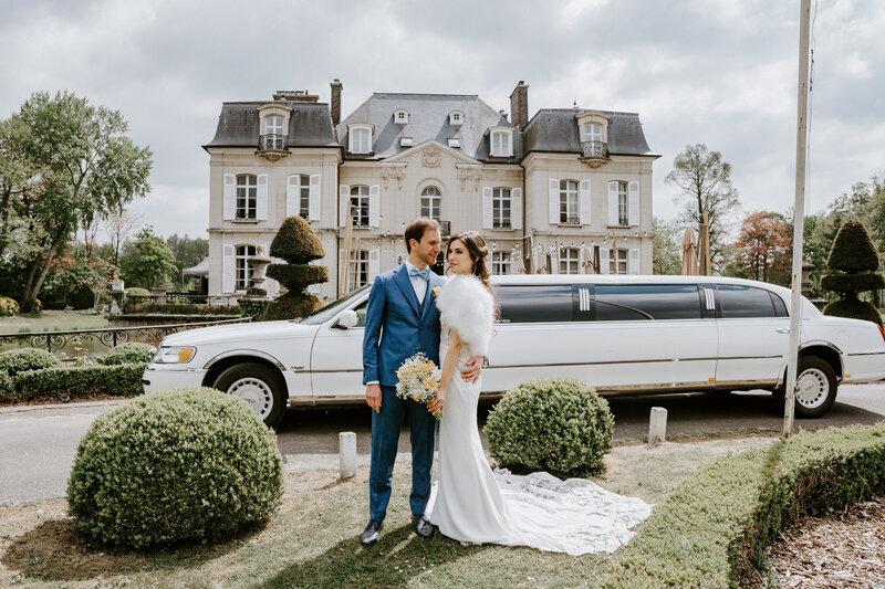 Couple in front of chateau in Paris on wedding day