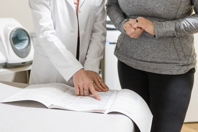 Jamie with a patient in the clinic going over test results