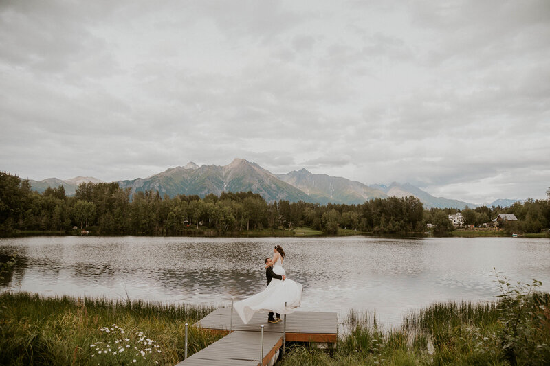 bride and groom near lake