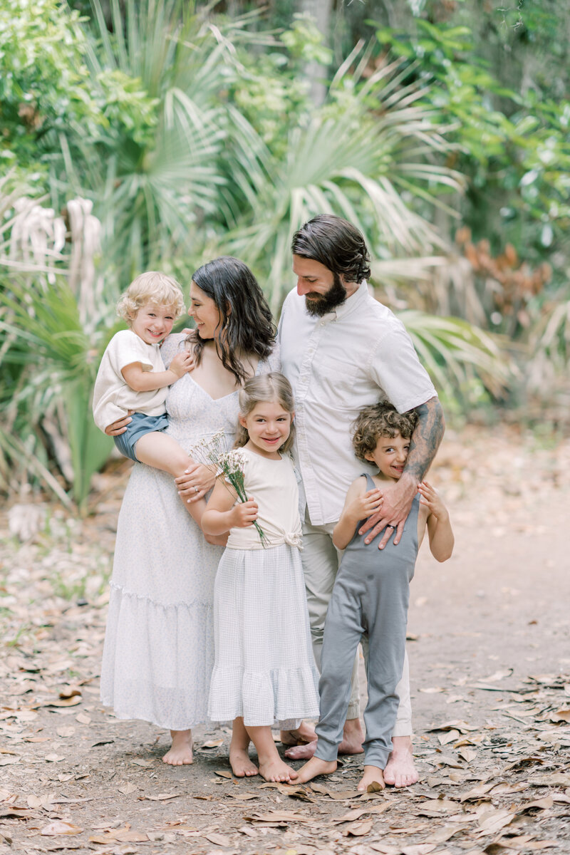 Family giggles as they stand together for a photo by Savannah Family Photographer Courtney Cronin