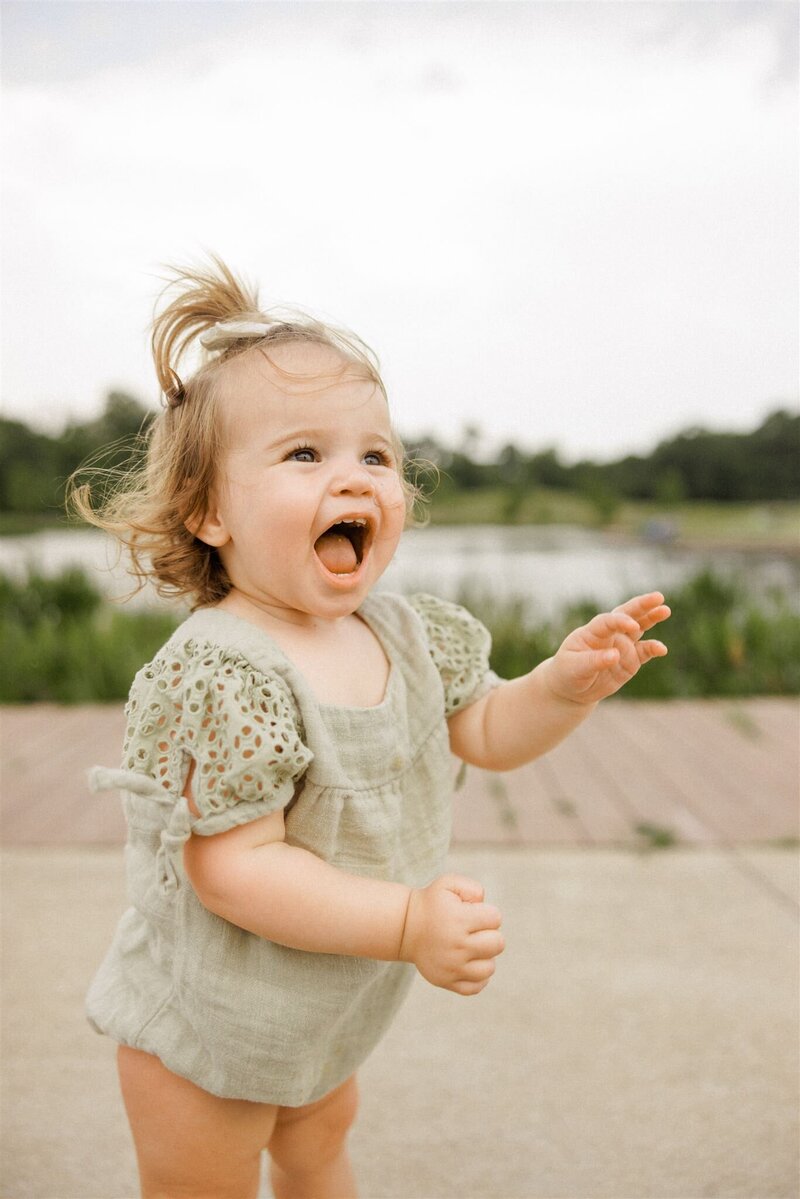 Toddler laughing near pod at Moncus Park