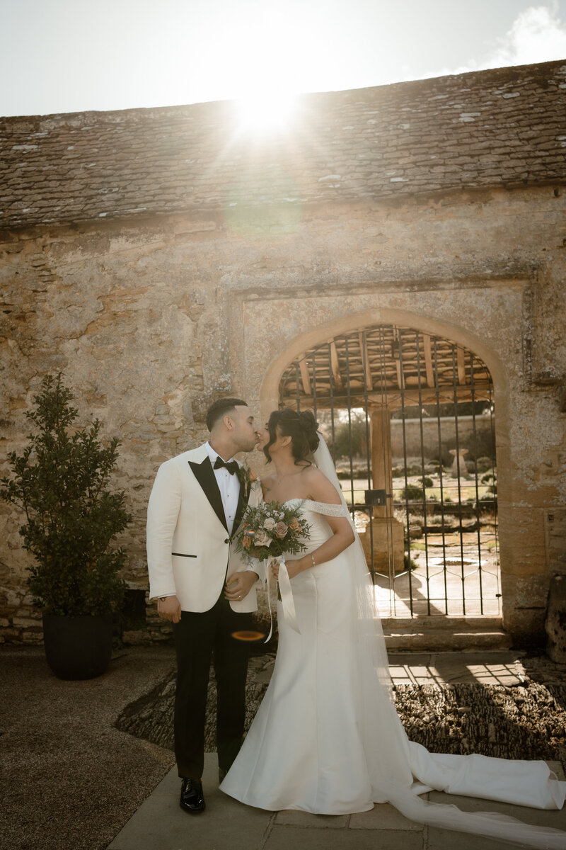 Cinematic photo of groom getting ready and looking out of the window