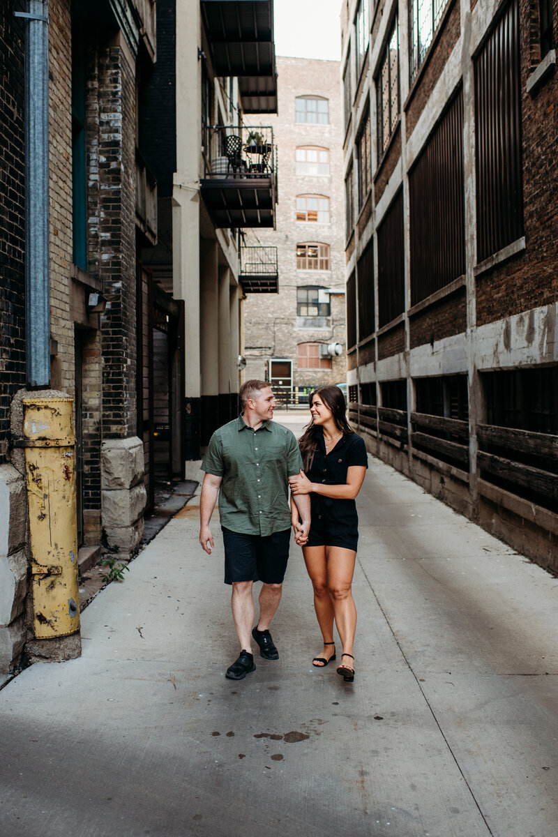 Man and woman walking down an alley