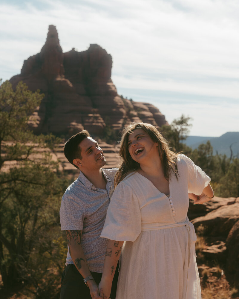 Adventurous couple hiking red rock trail in Sedona for their documentary-style elopement