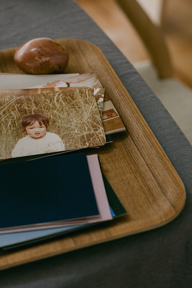 Photo stack, coloured paper on wooden tray