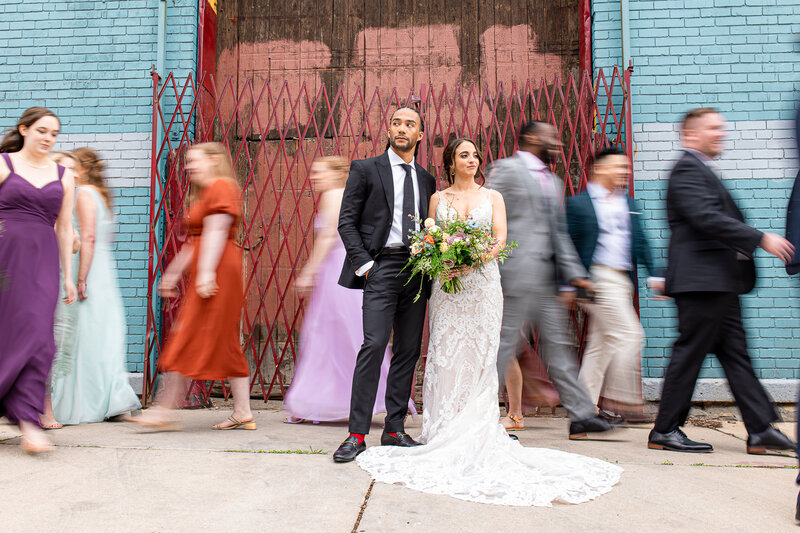 A couple poses with their wedding party outside Lacuna Lofts in Chicago