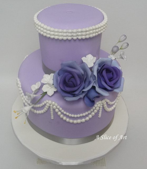 lavender fondant wedding cake with pearls and sugar roses