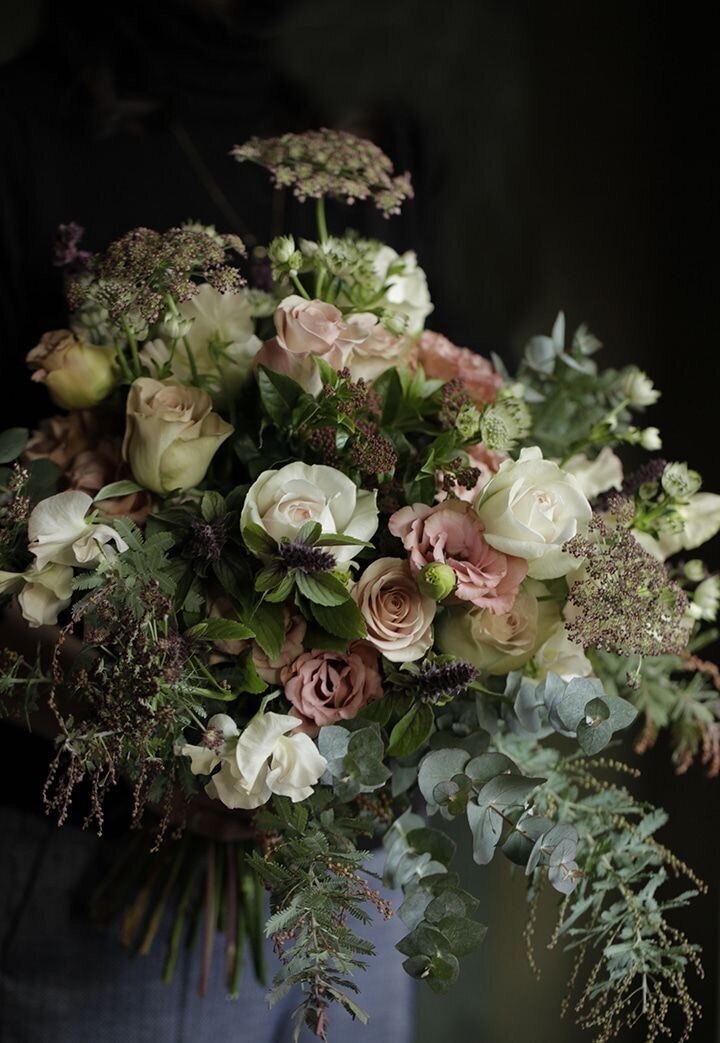 Season floral arrangement in soft pinks and greens, photographed in dim neutral light for East When Floral & Event Design.