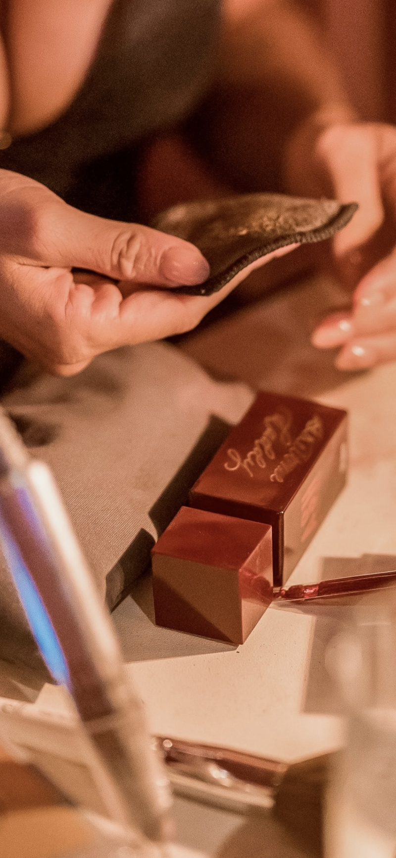 Process shot of Cat Lauren Calligraphy hand-engraving a fragrance for Demi Lovato