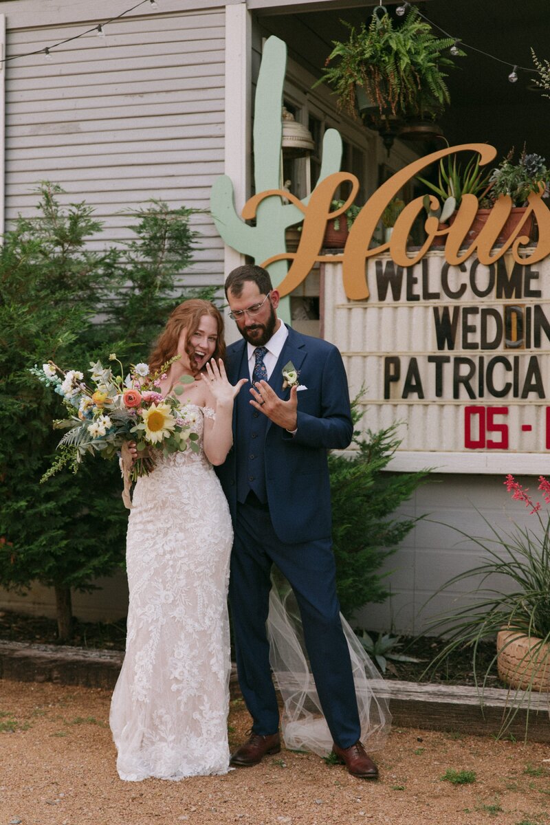 bride and groom showing us their wedding rings