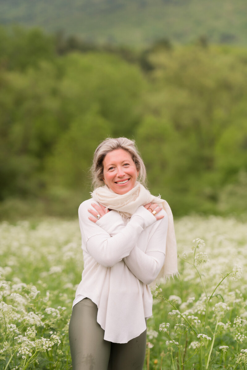 smiling woman standing in field