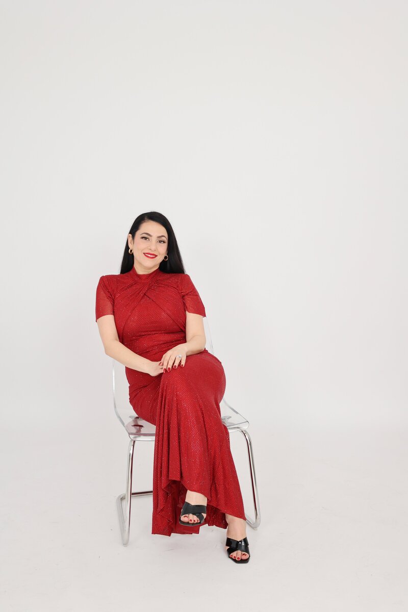 Gina Spanos, Vancouver boudoir photographer, sitting in her Burnaby studio — empowering women through elegant and authentic boudoir photography experiences.