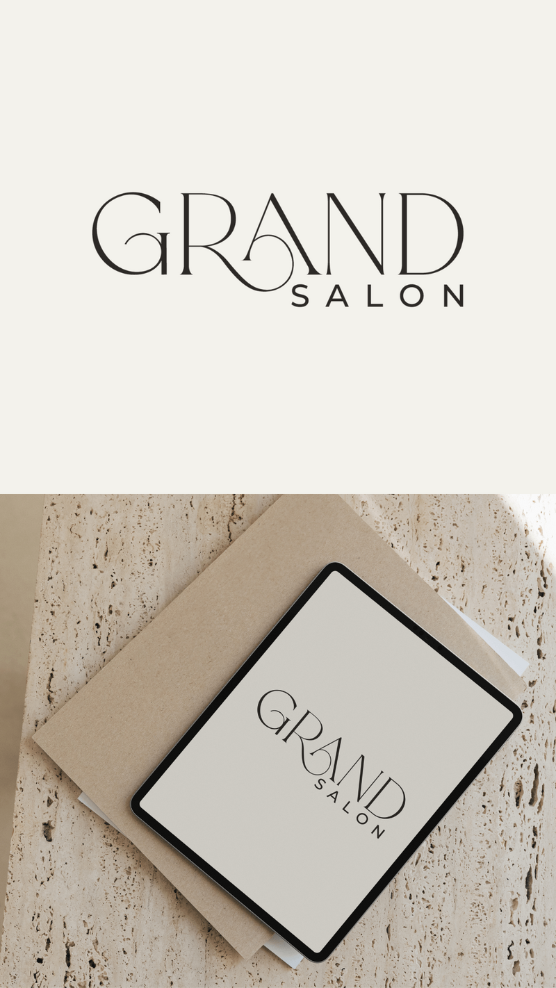 Logo with the words GRAND SALON in elegant, modern typography; the logo appears on a white background and is also shown on a tablet, highlighting a sleek hair salon website design atop a beige notebook on a textured surface.
