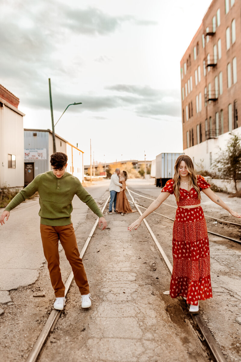 Two teenage kids walking together during urban pictures with Maternity Kansas City Photographers.