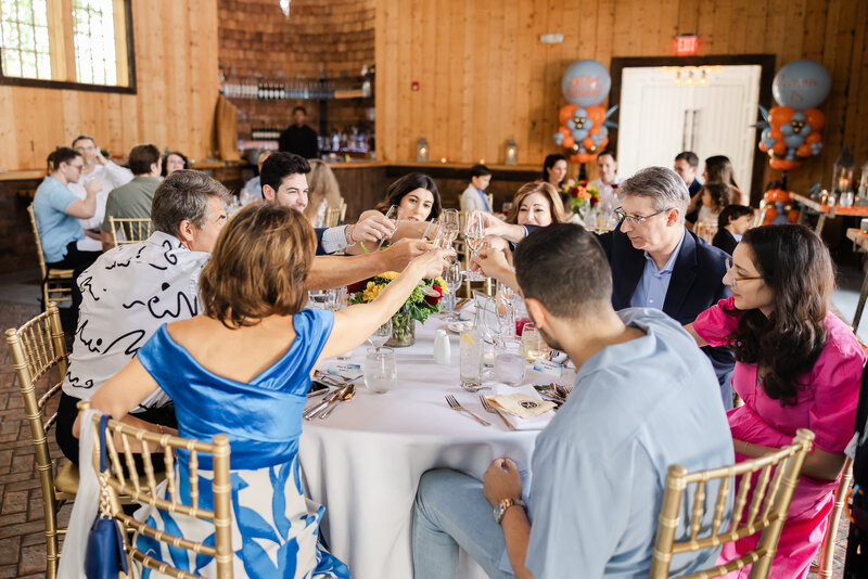 Clinking glasses at a toast at a formal birthday party