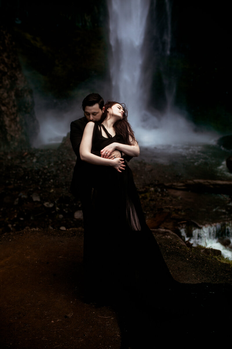 A powerful, moody elopement shoot by a cascading waterfall, highlighting the raw beauty of the Pacific Northwest.