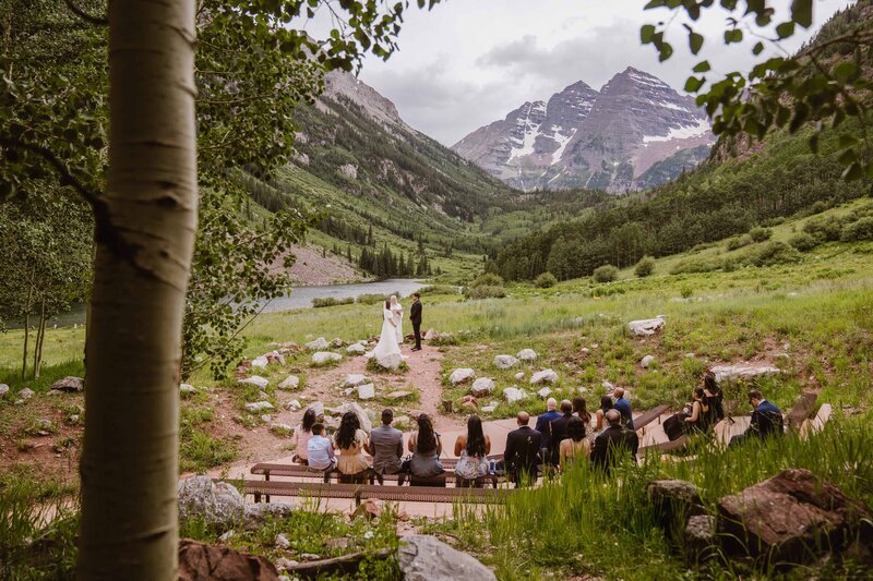 Wide image of a Maroon Bells Amphitheater wedding in Aspen, Colorado taken by Colorado wedding photographer Avenir Photo Co.