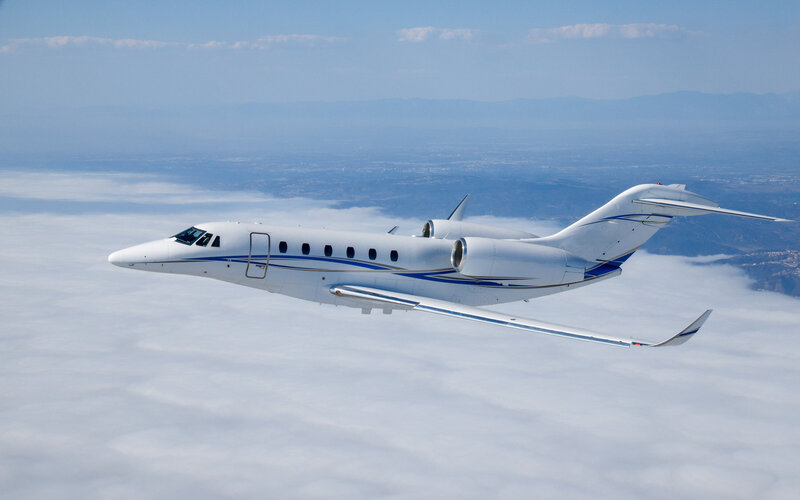citation x plane flying through sky for private charters
