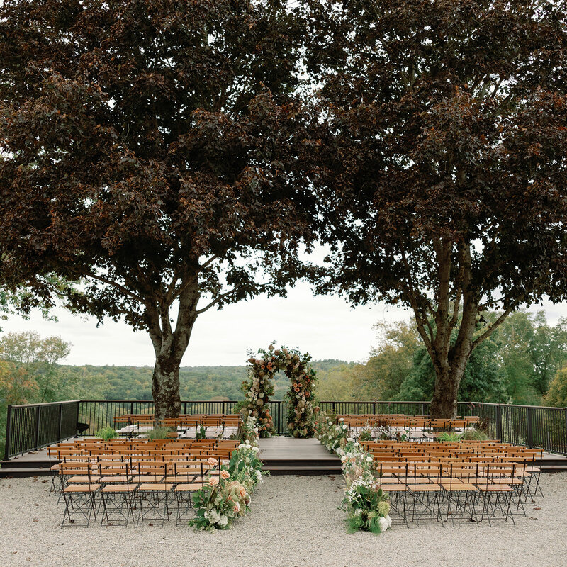 Aerial view of the outdoor patio at Willow Hill Event Venue, showcasing a pool, lush greenery, and a spacious, scenic setting for events.