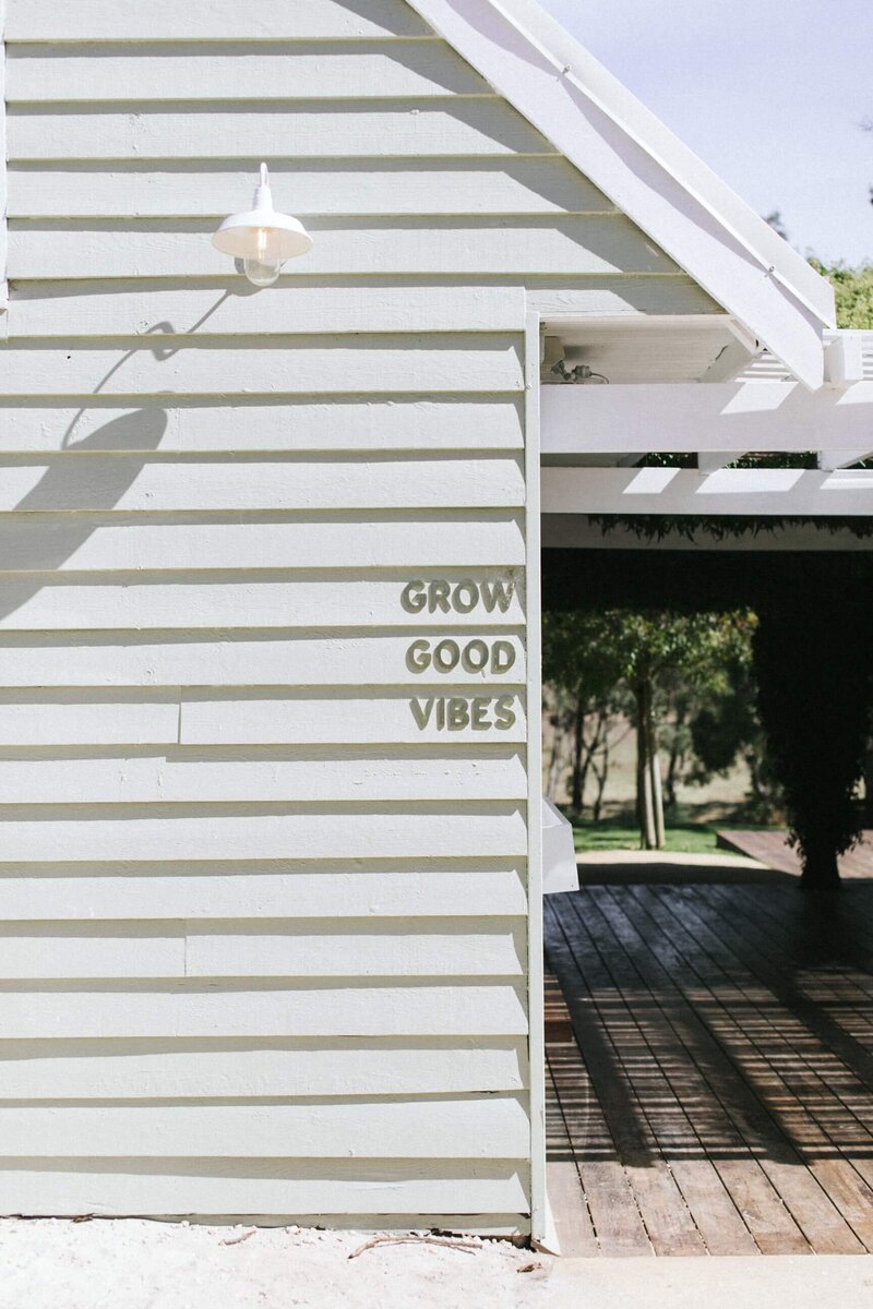 shiplap clad shopfront with grow good vibes sign
