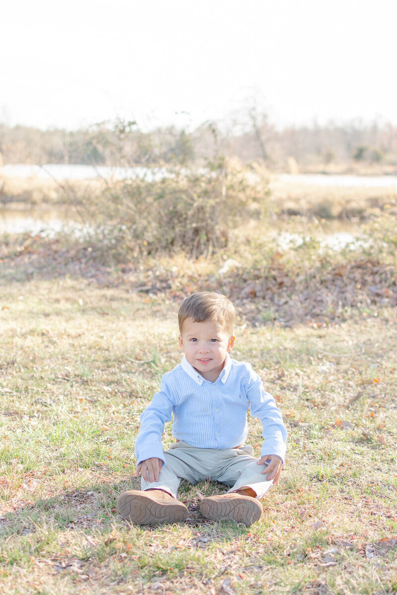 Toddler boy sitting on the grass during Centreville, Virginia session