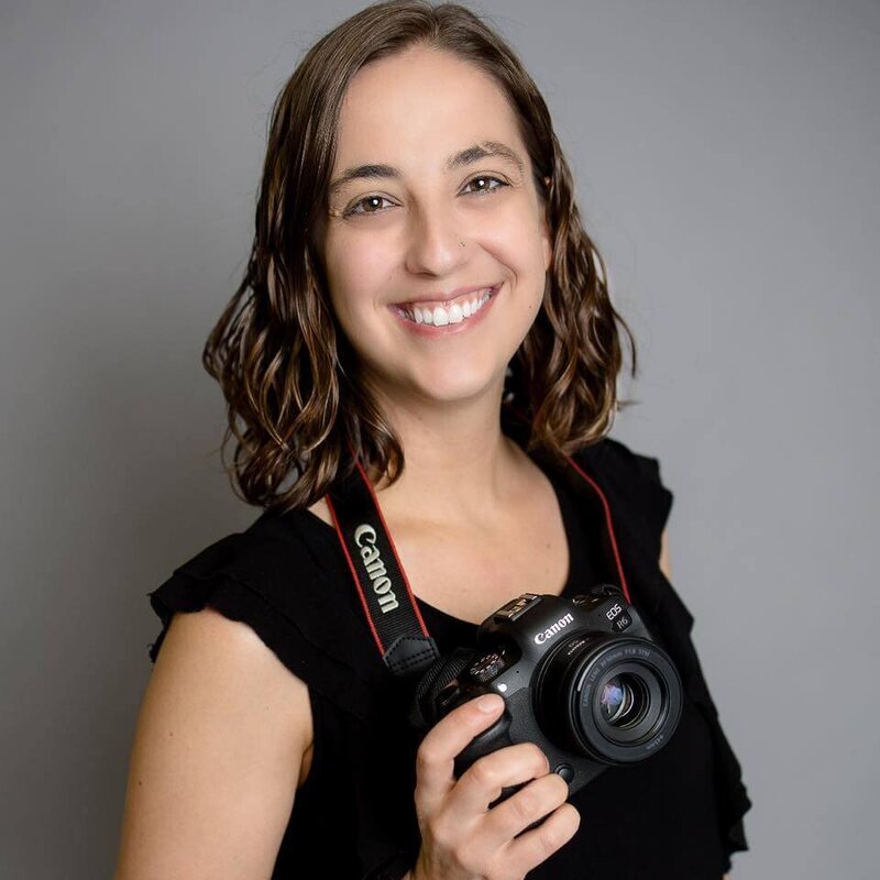 Shelby from Baby Bump & Beyond Photography smiling with her camera, featured in a testimonial about HoneyBook systems and VIP Day support.